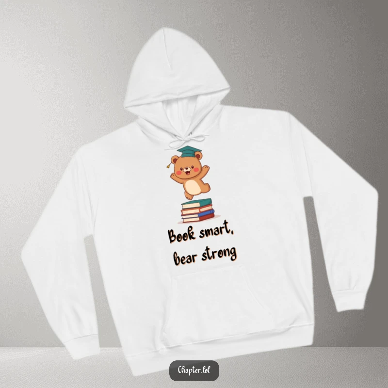 Funny graduation bear hoodie depicting an energetic brown bear with a graduation cap leaping over a stack of books. Cozy and humorous academic wear.